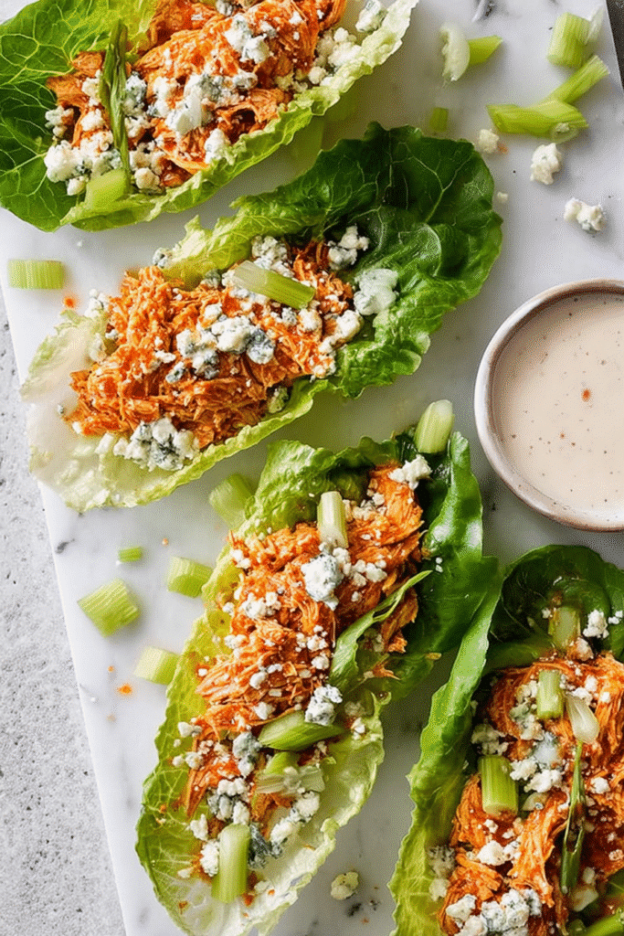 Crisp lettuce cups filled with shredded buffalo chicken, crumbled blue cheese, and celery for a fresh spicy bite.
