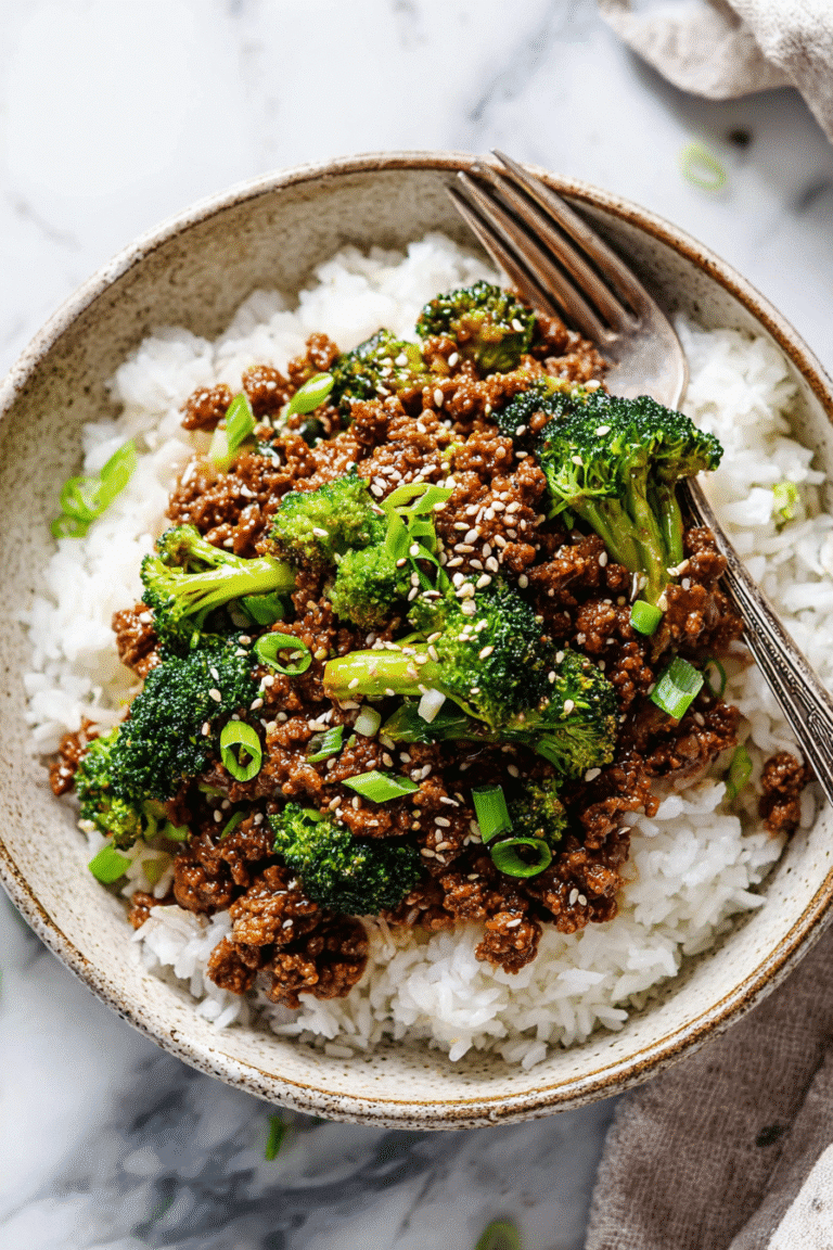 Ground beef and broccoli served over fluffy white rice, topped with sesame seeds and fresh green onions for a quick dinner