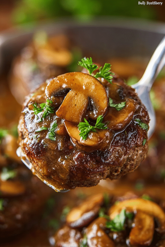 Tender Salisbury steak topped with mushrooms and rich brown gravy, garnished with parsley for a comforting homemade meal
